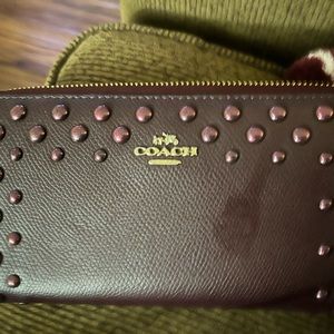 Burgundy coach wallet with gold accents & rivets